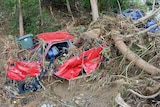 Wrecked cars in the New Town rivulet, following the flood of May 11, 2018