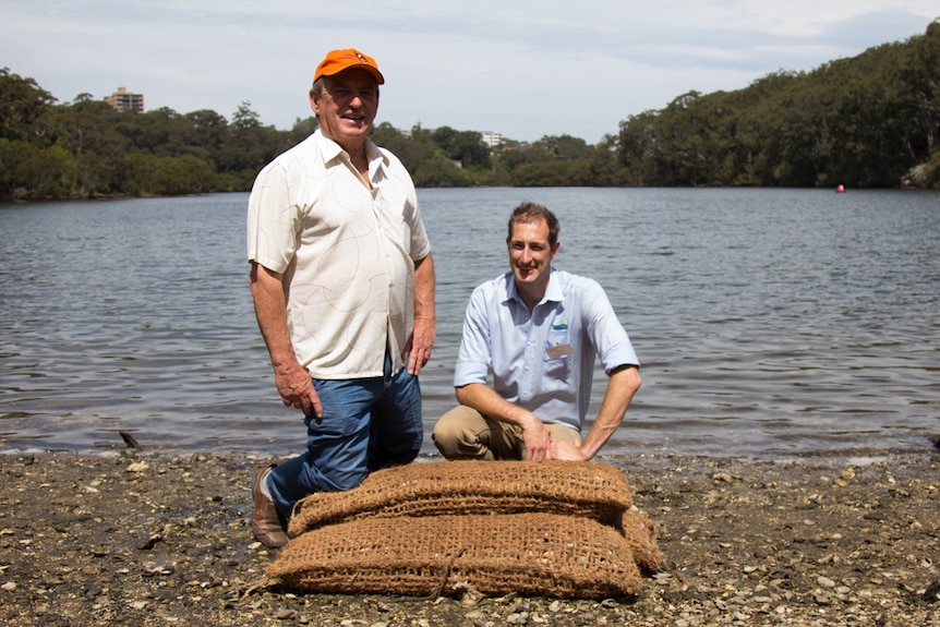 Andy Myers and Richard Halmyn-Harris with the oyster bags from the OceanWatch trial