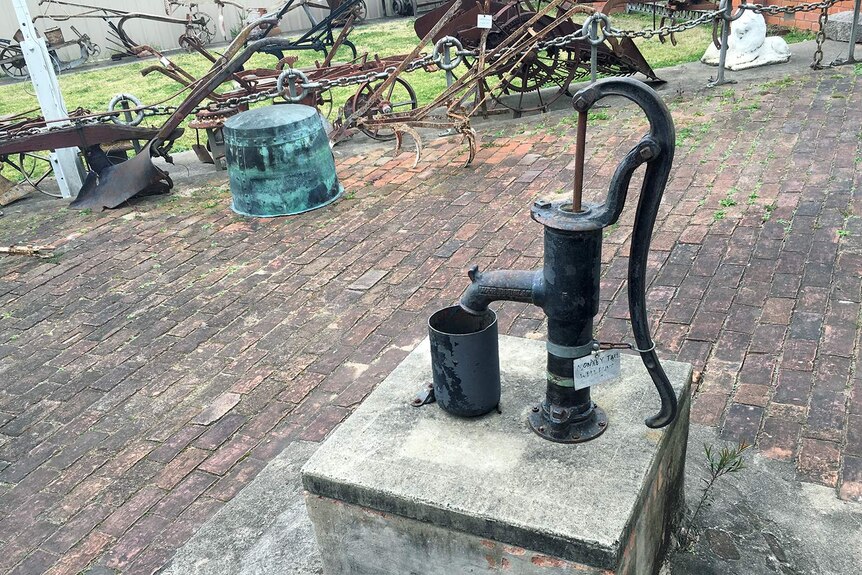 Hand pump over an underground tank at the old Bega Family Hotel, now the Bega Pioneers Museum