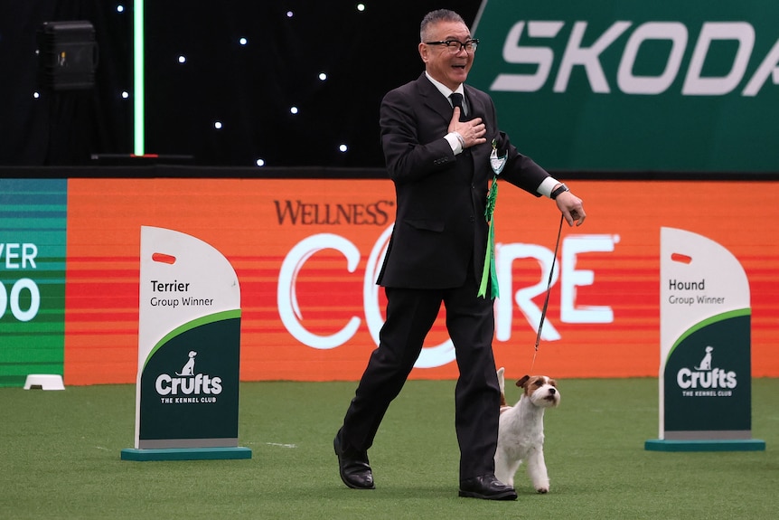 A Japanese handler celebrates as his Jack Russell Terrier wins second place.
