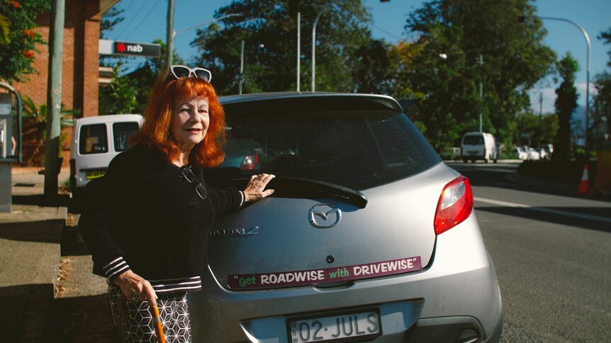 Ziggy Koenigseder, aged 71 standing behind a car she is about to drive.