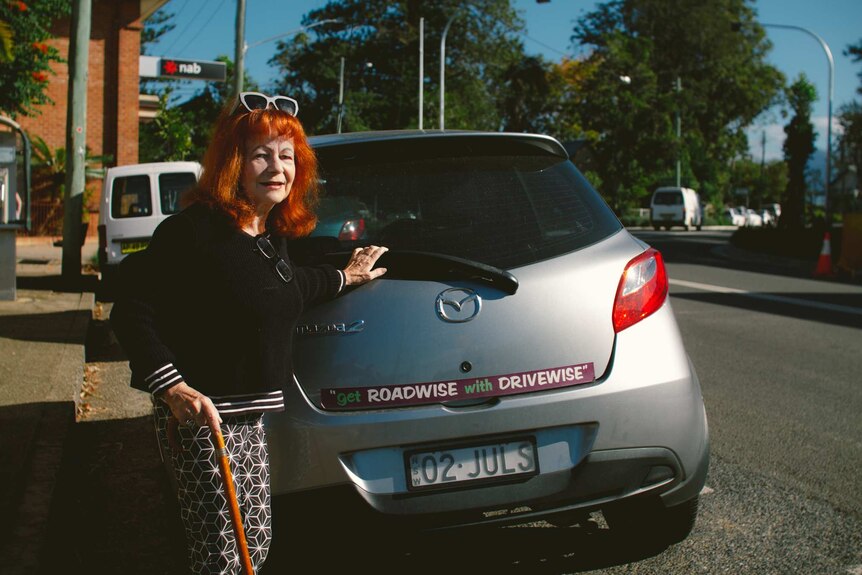 Ziggy Koenigseder, aged 71 standing behind a car she is about to drive.