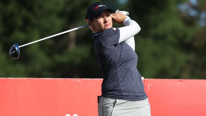 An Australian female golfer watches a tee shot during a tournament in Michigan.