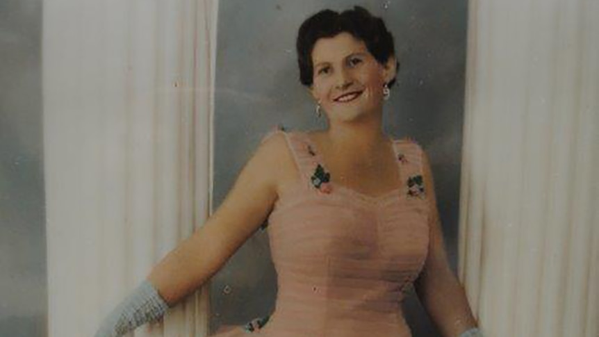 A historic photo of a woman in a ballgown