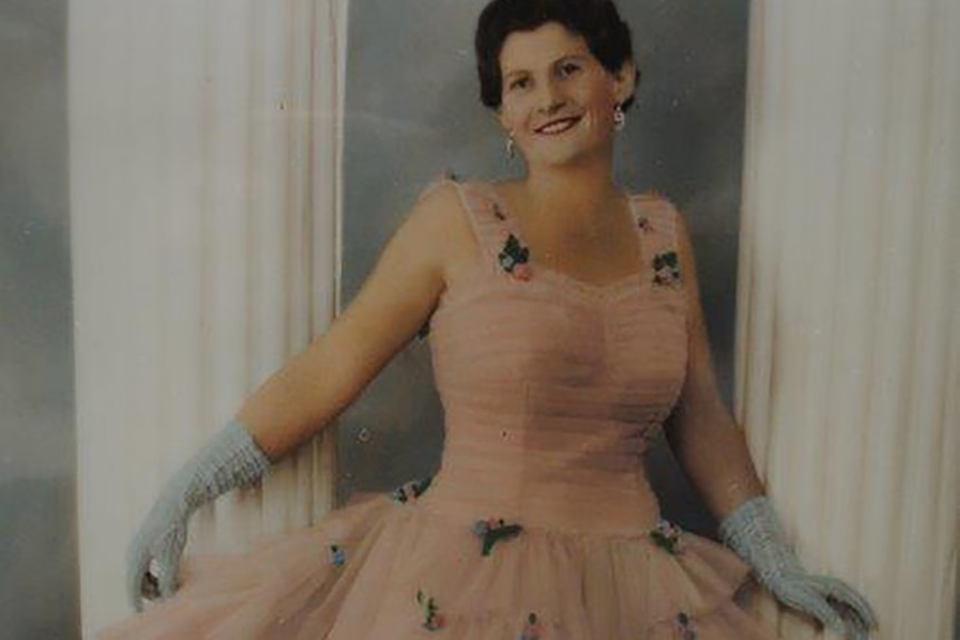 A historic photo of a woman in a ballgown.