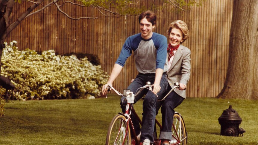 Nancy Reagan rides a tandem bike