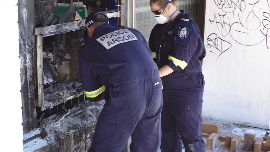 Police investigate the scene after an ATM in High Wycombe, Perth, was set alight.