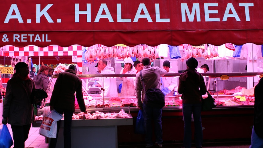 A butchery with a banner labelled "Halal Meat" hanging above the store.