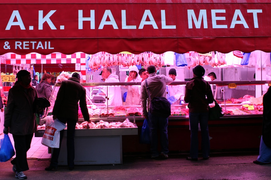 A butchery with a banner labelled "Halal Meat" hanging above the store.
