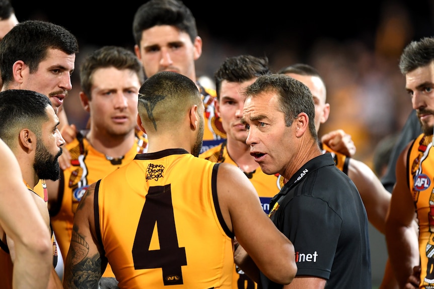 Hawthorn coach Alastair Clarkson looks a player in the eye as he speaks in the three quarter-time huddle. 