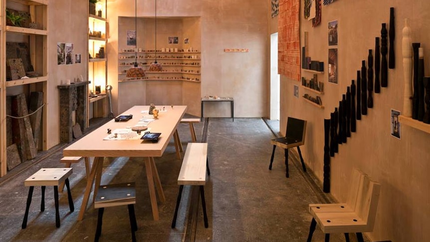 Assemble's Granby Workshop showroom with a long wooden table and bench seats.