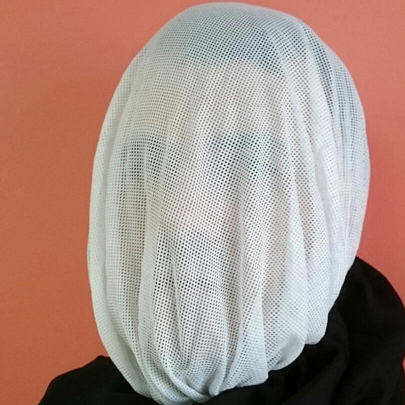 A mesh hood fully covering a man's face.