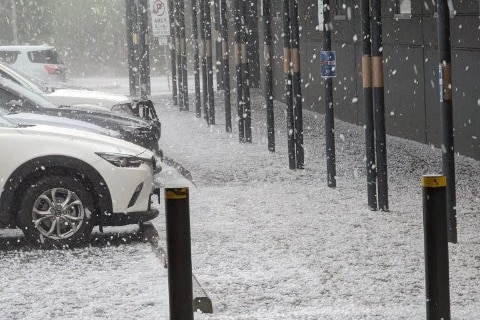 A blanket of hail over a carpark looks like snow