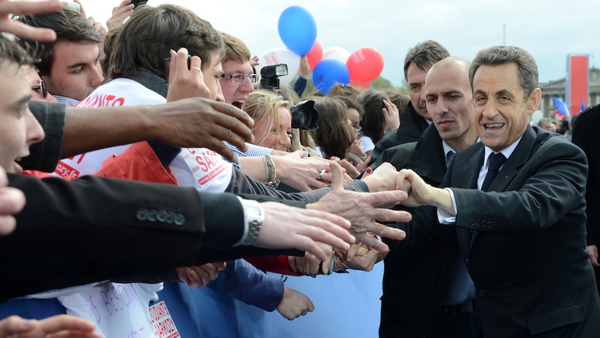 French president Nicolas Sarkozy leaves a political rally in Paris