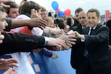 French president Nicolas Sarkozy leaves a political rally in Paris