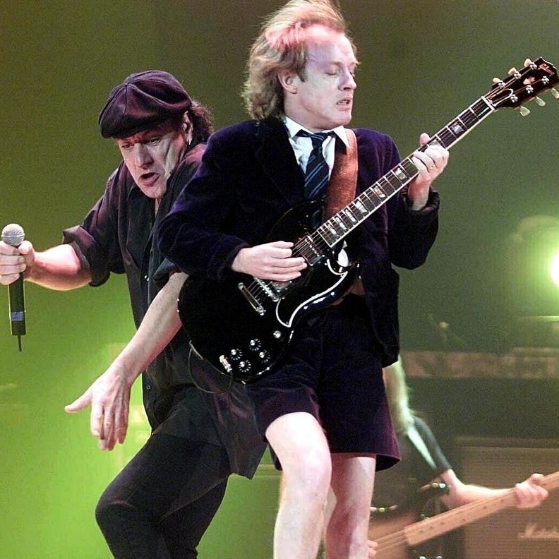 Angus Young (right) is the only original member of AC/DC remaining.
