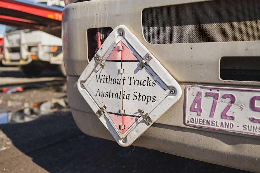 A sign on the front of a truck reading 'Without Trucks Australia Stops'
