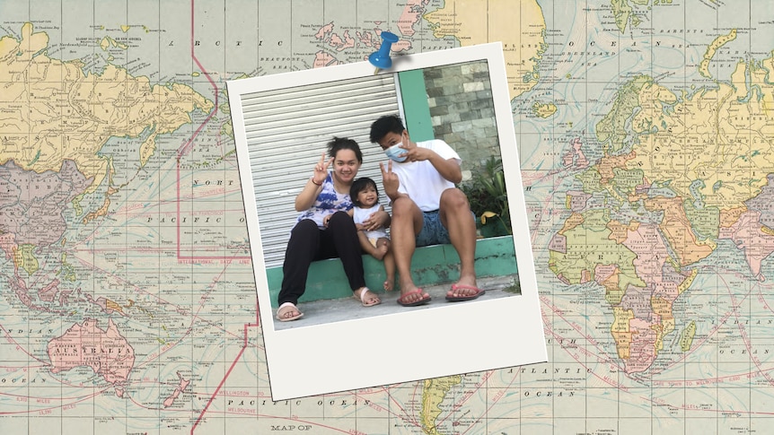 An old style world map with a Polaroid of a smiling family with young child.