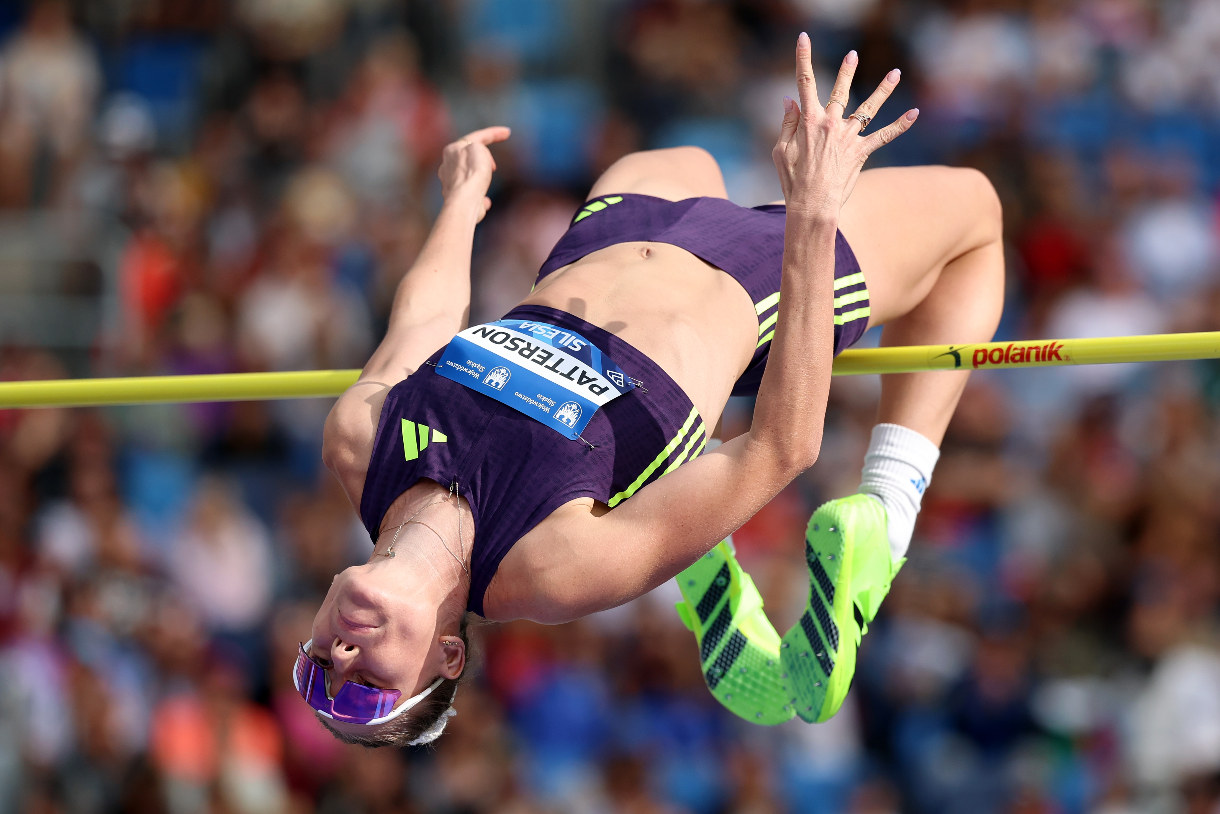 An athlete is pictured midway through a high jump.