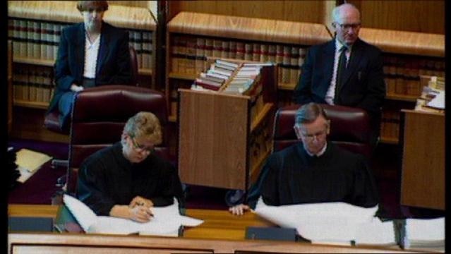 Judges sit at table in High Court
