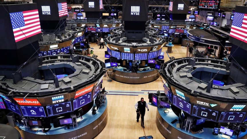 A worker cleans the floor of the New York Stock Exchange as the building prepares to close indefinitely due to the coronavirus.