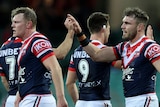 Roosters players high-five each other during an NRL game.