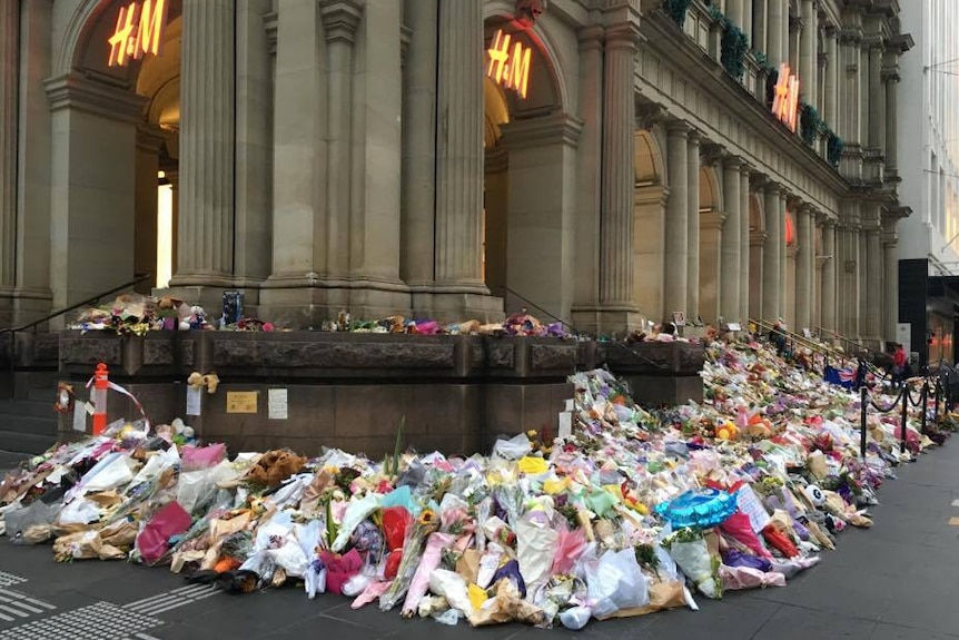 Flowers, toys and cards at a make-shift memorial in Bourke Street mall.