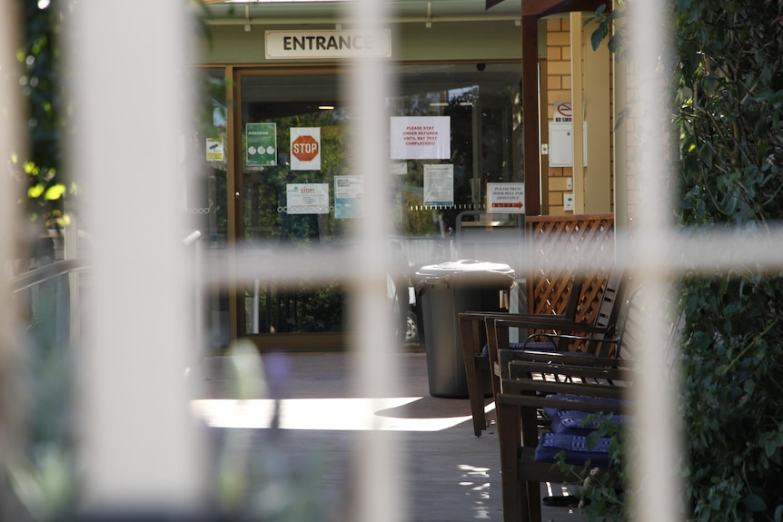 Entrance to an aged care facility. Photo taken from behind a gate.