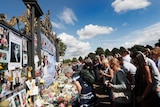 People crowd around the gates of Kensington Palace in London to pay tribute to the late Diana.