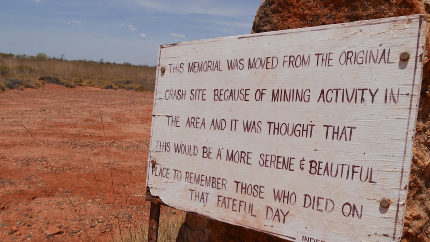 A sign indicating that the original memorial plaque was moved after gold was found at the site.
