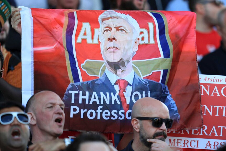 Arsenal fans cheer for outgoing manager Arsene Wenger after their game against Huddersfield.