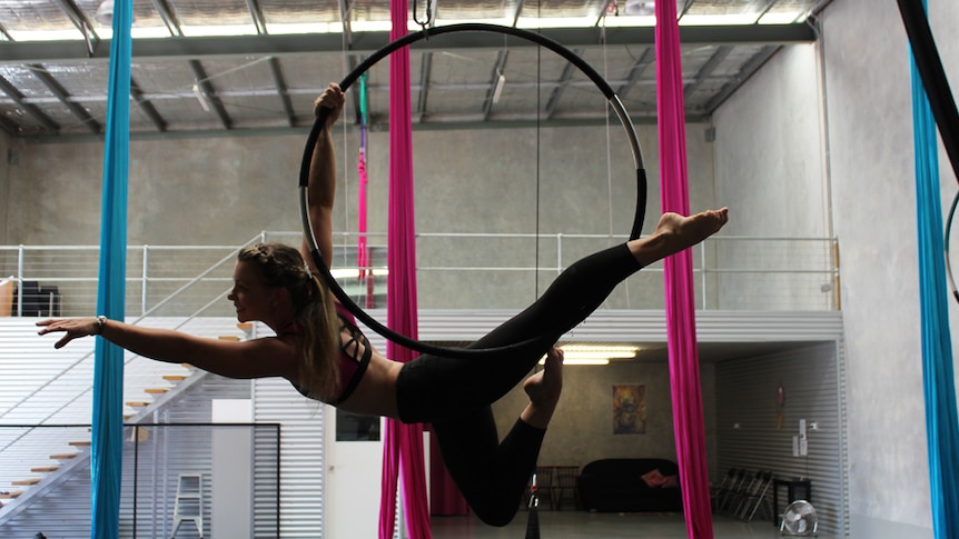 Aerialist Kayleigh McMullen strikes a pose while training to compete in the United States.