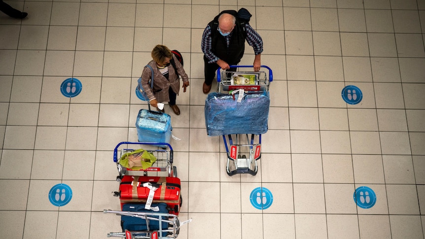 Aerial shot of international travellers with luggage at airport