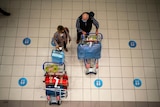 Aerial shot of international travellers with luggage at airport