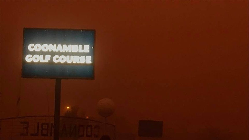 A sign saying Coonamble golf course is obscured by a dust storm