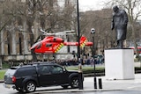 An air ambulance lands in London's Parliament Square after a terrorist attack on Westminster Bridge on March 22, 2017.