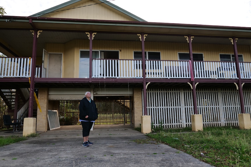 Teresa in front of her grandmother's house, which in unsafe for occupancy