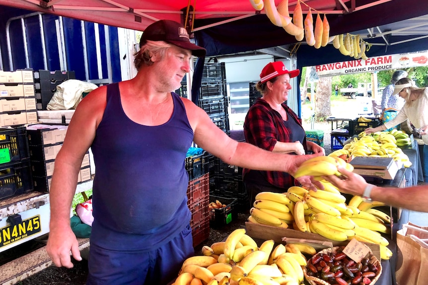 Man and woman working at banana stall