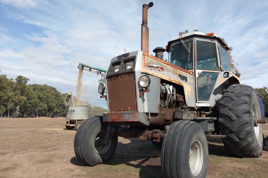 An old farm tractor and feed silo on a drought-affected Briagolong farm in Gippsland