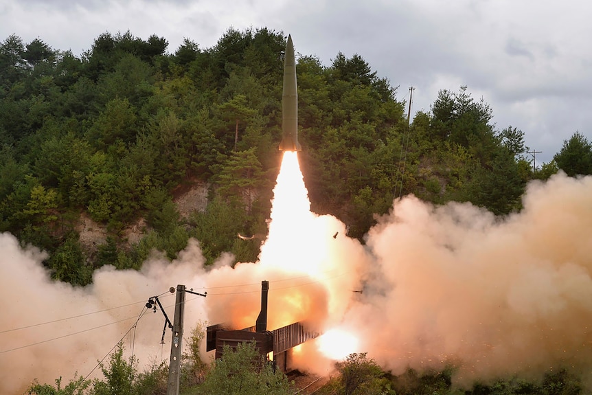 A missile launches from a train. 