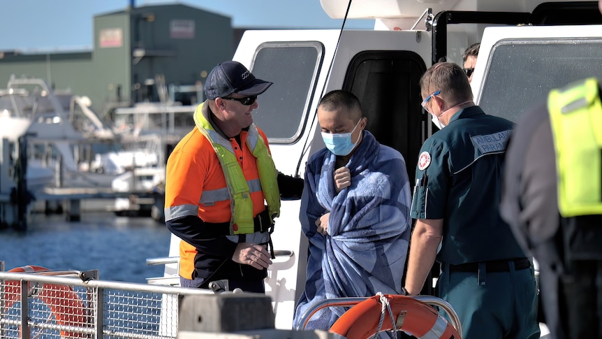 Sailor walking from rescue boat at Geraldton port.