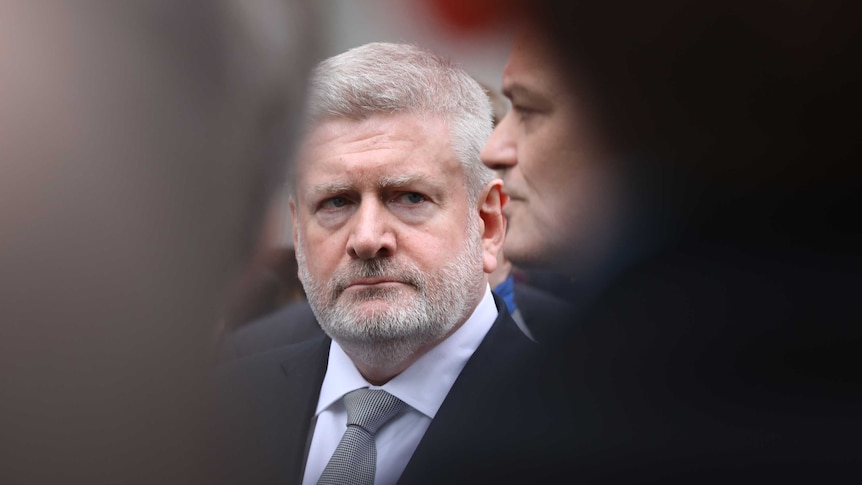 Tight shot of Fifield looking at Cormann with a concerned expression.