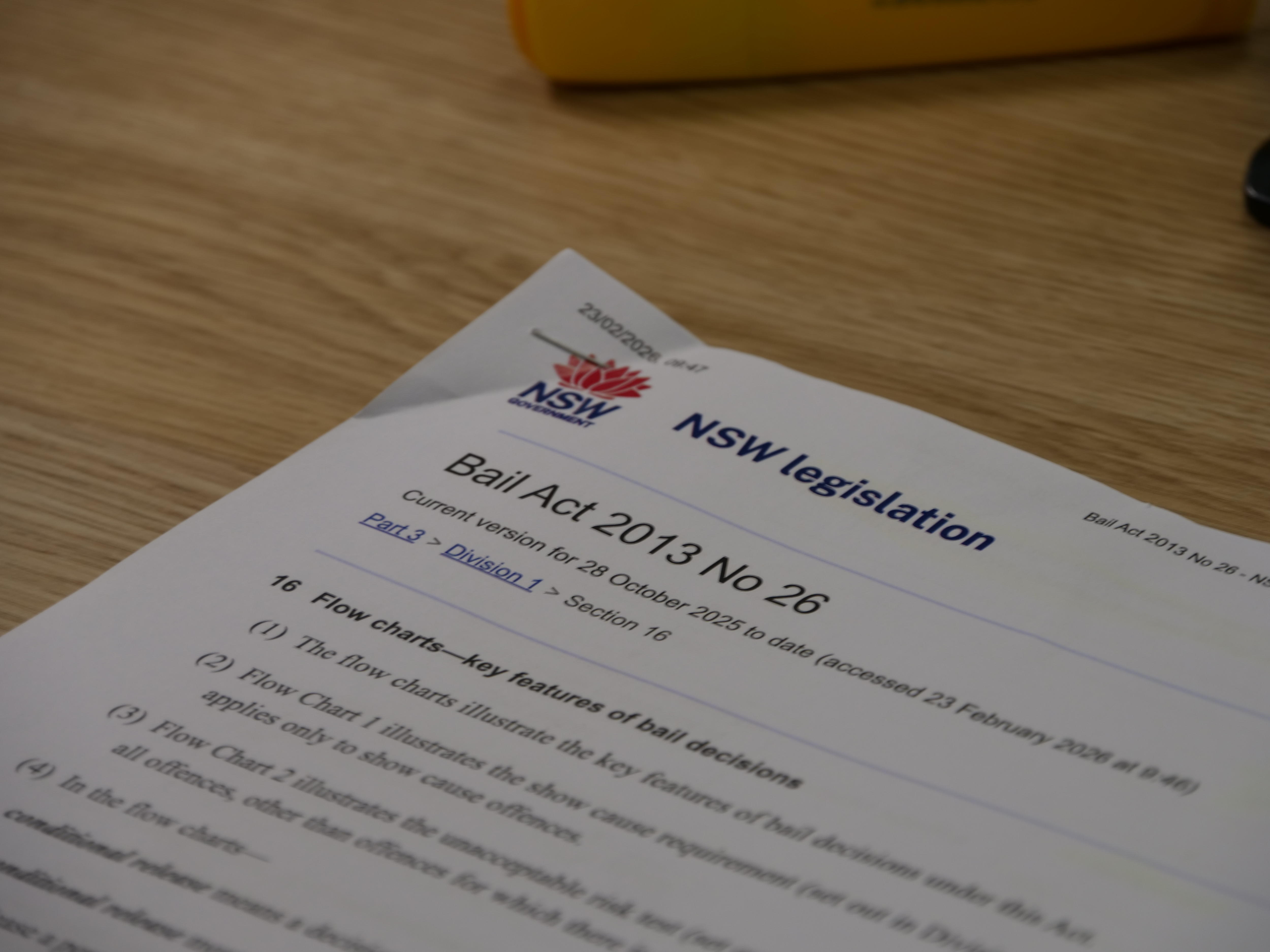 A paper copy of the bail reform act 2013 on a desk. 