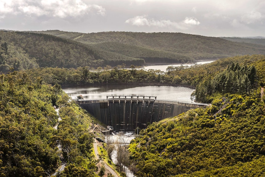 An aerial photo of a dam with water in it.