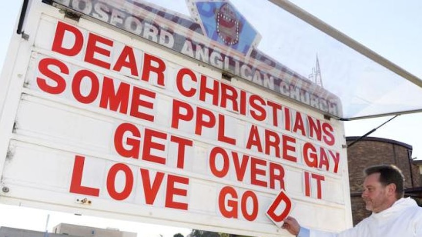 Father Rod Bower of Gosford Anglican Church with his church signboard depicting a pro-gay message.
