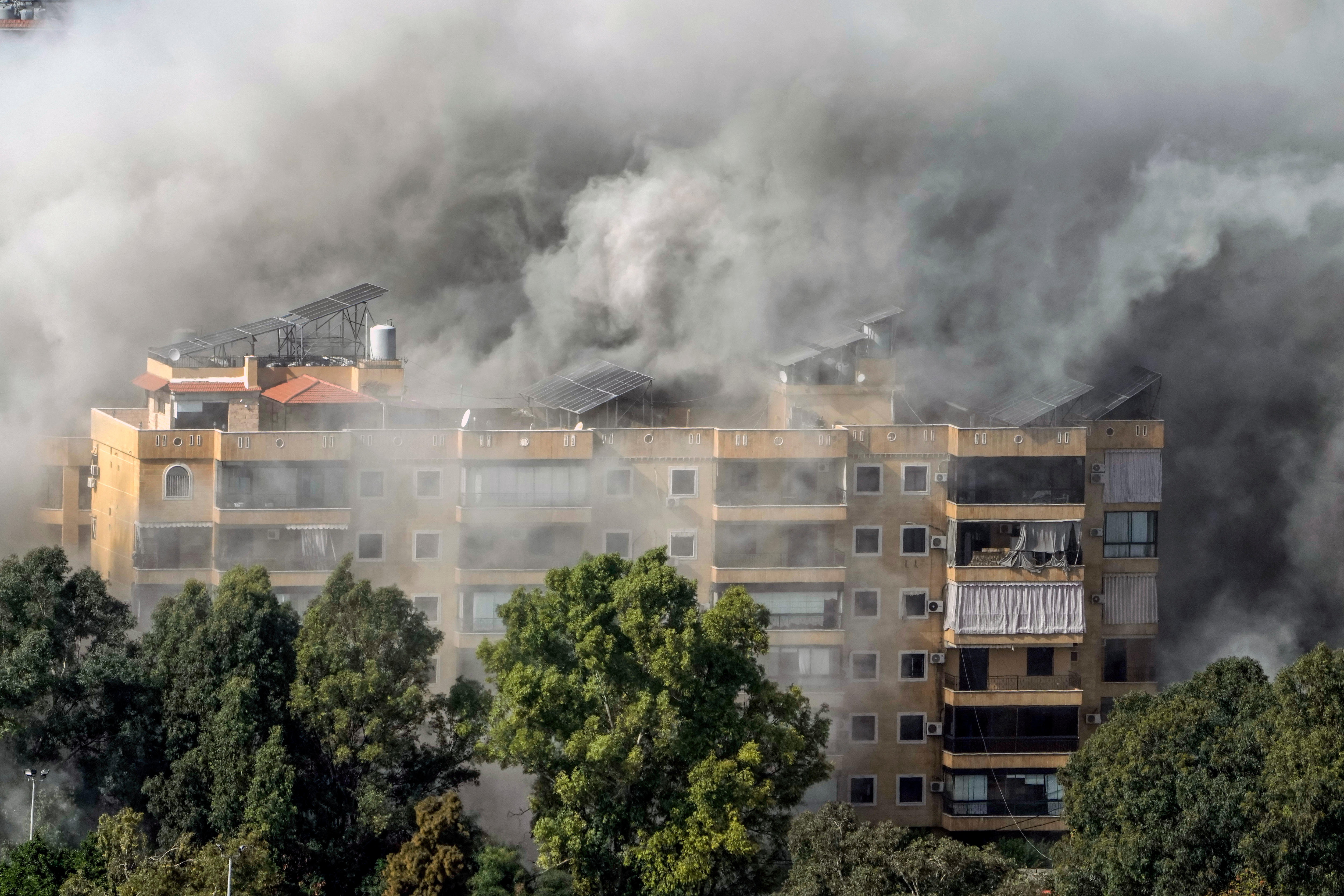 Smoke pouring out of a Beirut apartment block after being hit by an airstrike.