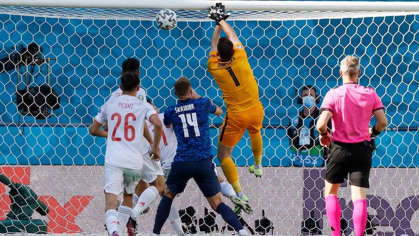 Martin Dubravka jumps for the ball with his hands above his head
