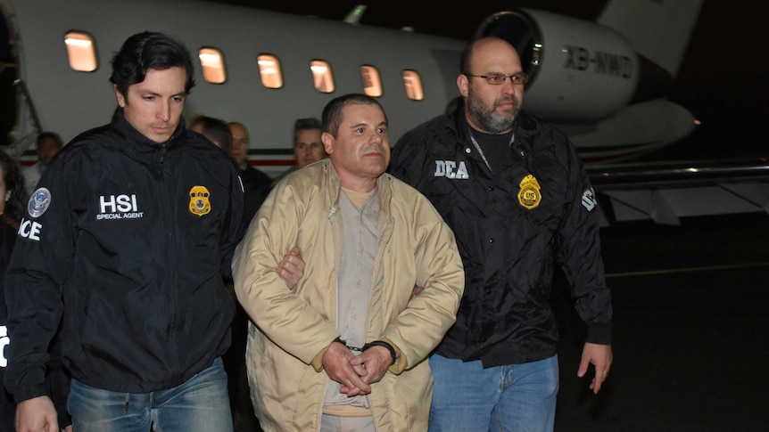 Joaquin "El Chapo" Guzman is escorted as he arrives in New York.