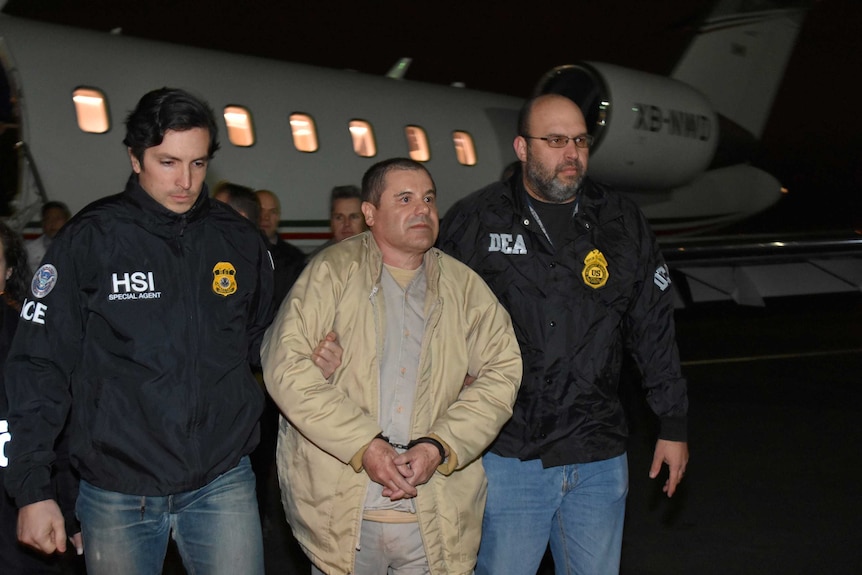 Joaquin "El Chapo" Guzman is escorted as he arrives in New York.