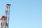 Huge cranes stand over cargo containers at Fremantle Harbour